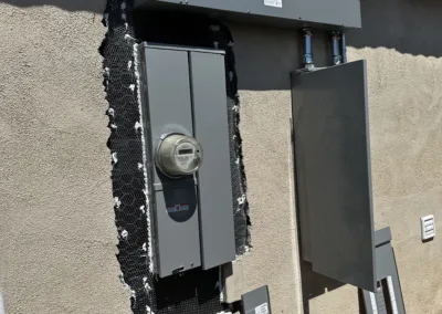 An electrical panel on the side of a house.